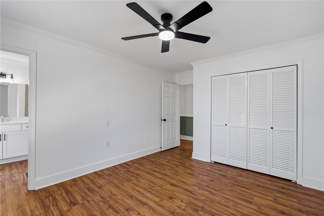 208 Williamsburg Road Anderson, SC 29621 - Photo 28 of 48 Rich wood-look flooring and crown molding complement this comfortable bedroom space.