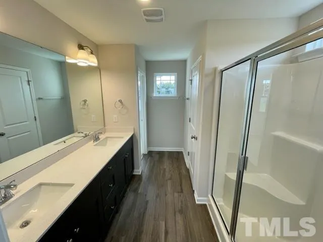 a bathroom with a double vanity sink and a mirror