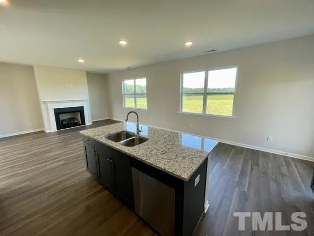 a kitchen with sink cabinets and wooden floor