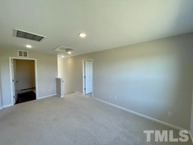 a view of an empty room with a fireplace