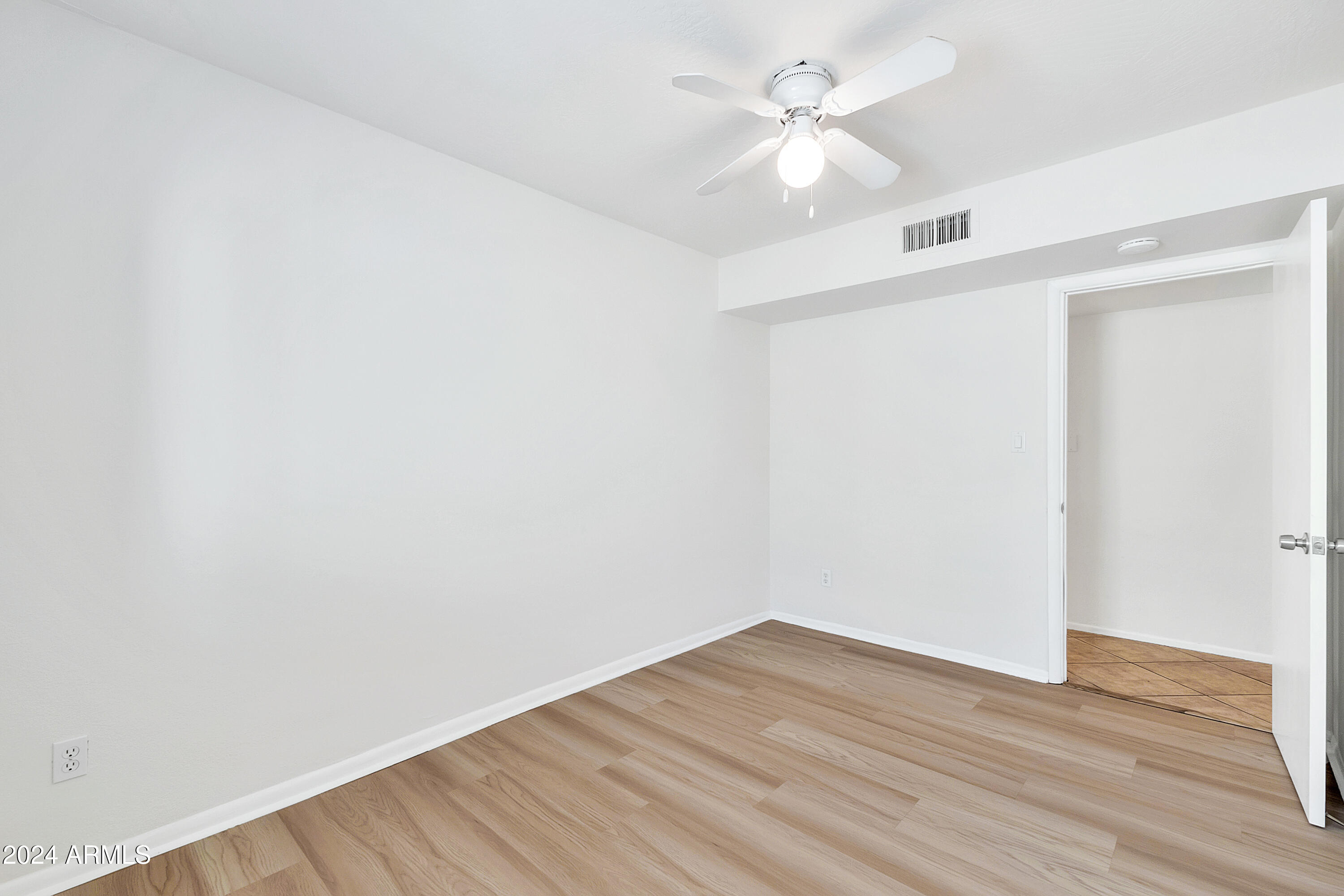 5234 East Blanche Drive Scottsdale, AZ 85254 - Photo 14 of 20 an empty room with wooden floor and fan