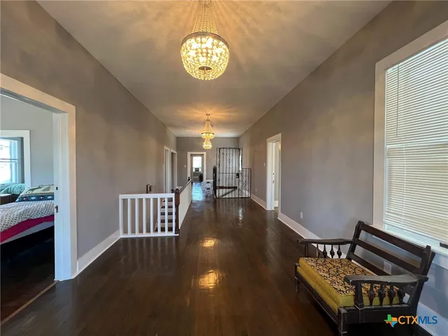 a view of a hallway with seating area