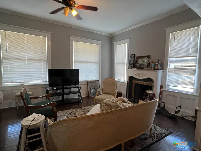 a living room with furniture a fireplace and a flat screen tv