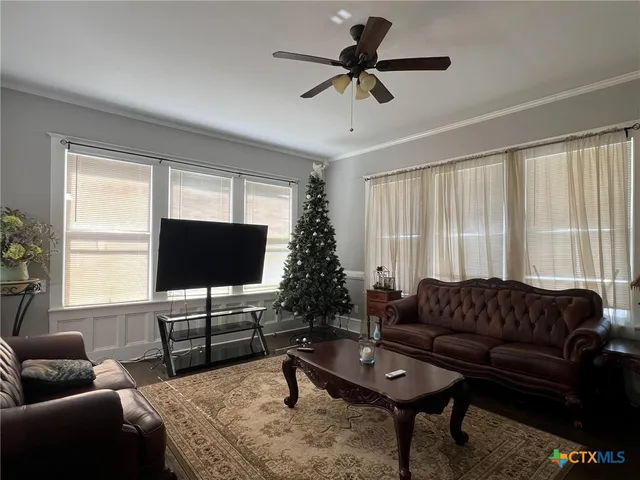 a living room with furniture and a flat screen tv