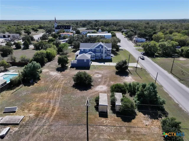 a view of a terrace with lawn chairs and potted plants
