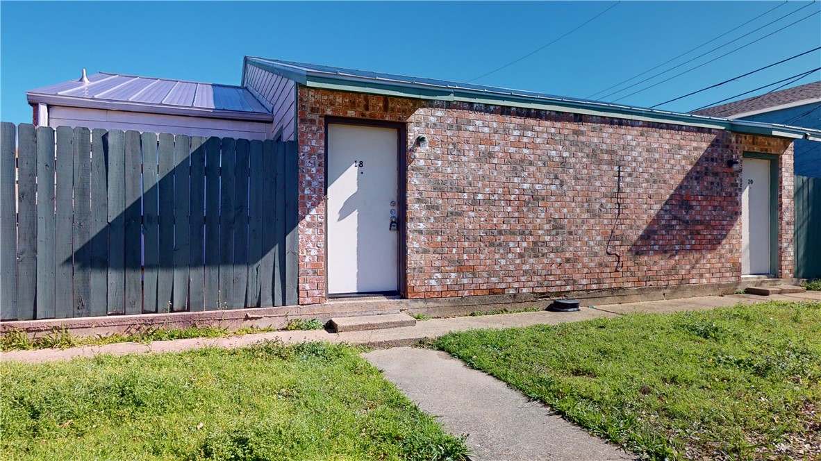 725 Peppertree Drive, Unit 30 Bryan, TX 77801 - Photo 2 of 14 a view of a backyard with a large tree and wooden fence