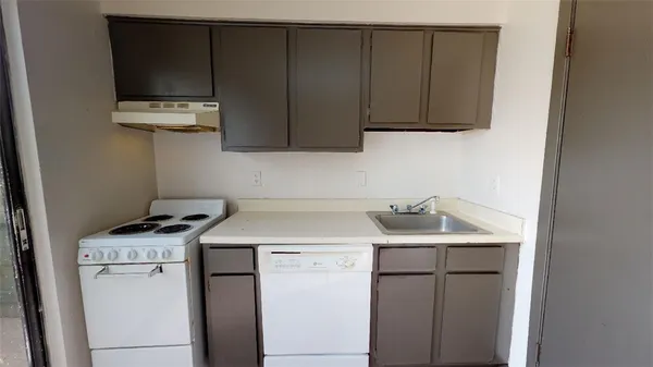 a utility room with sink dryer and washer