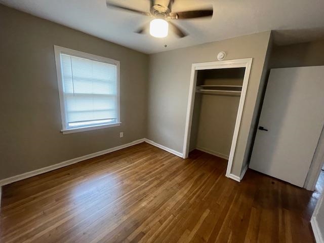 3602 Hallbrook Street Memphis, TN 38127 - Photo 3 of 12 Unfurnished bedroom featuring dark wood finished floors, a ceiling fan, and a closet