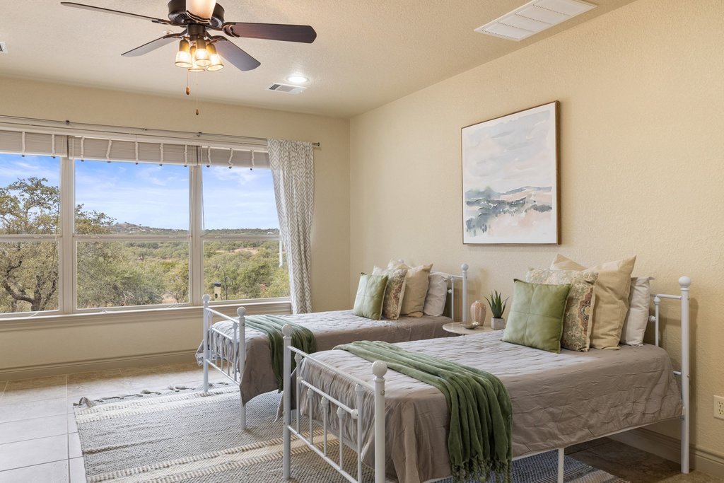 232 Crooked Oak Round Mountain, TX 78663 - Photo 25 of 40 Bedroom with ceiling fan and tile patterned floors