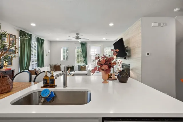 a kitchen with a sink a counter and chairs