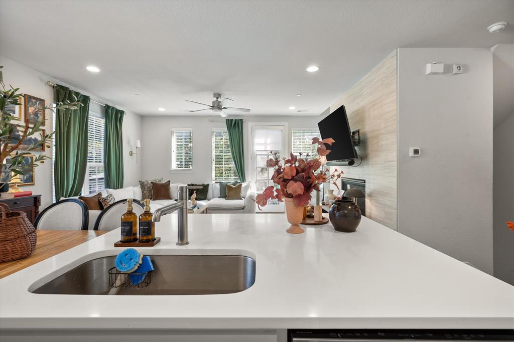 1900 Caddo Street, Unit 4 Dallas, TX 75204 - Photo 11 of 36 a kitchen with a sink a counter and chairs