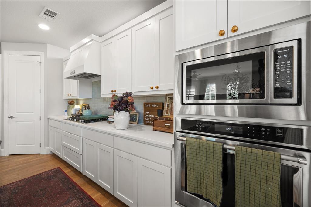 1900 Caddo Street, Unit 4 Dallas, TX 75204 - Photo 12 of 36 a kitchen with stainless steel appliances granite countertop a stove and a microwave