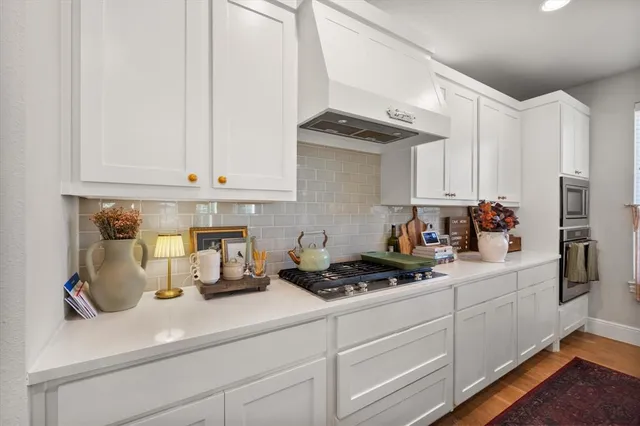 a kitchen with white cabinets and a sink