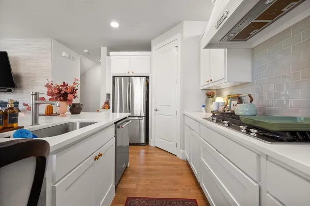 a kitchen with a sink stainless steel appliances and cabinets