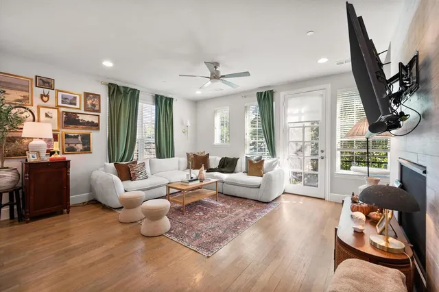 a living room with furniture fireplace and a large window