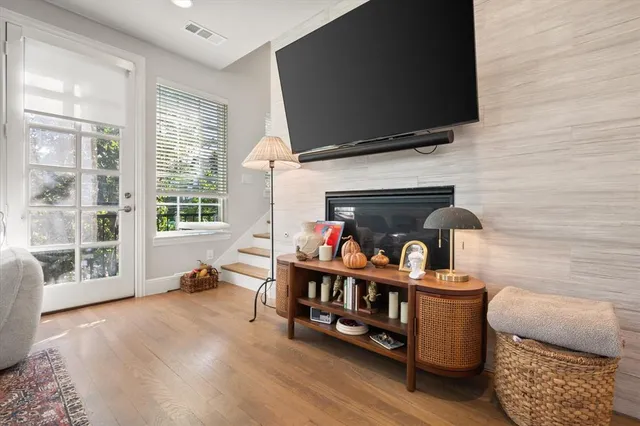 a living room with furniture a flat screen tv and a fireplace