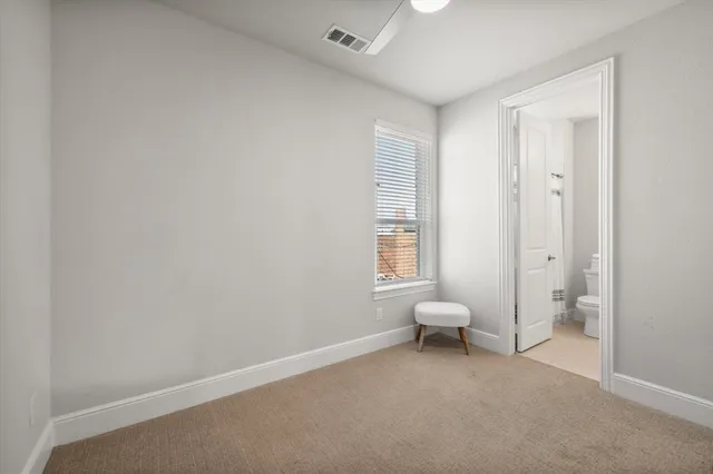 a living room with a chair and a window