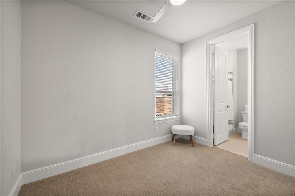 1900 Caddo Street, Unit 4 Dallas, TX 75204 - Photo 24 of 36 a living room with a chair and a window