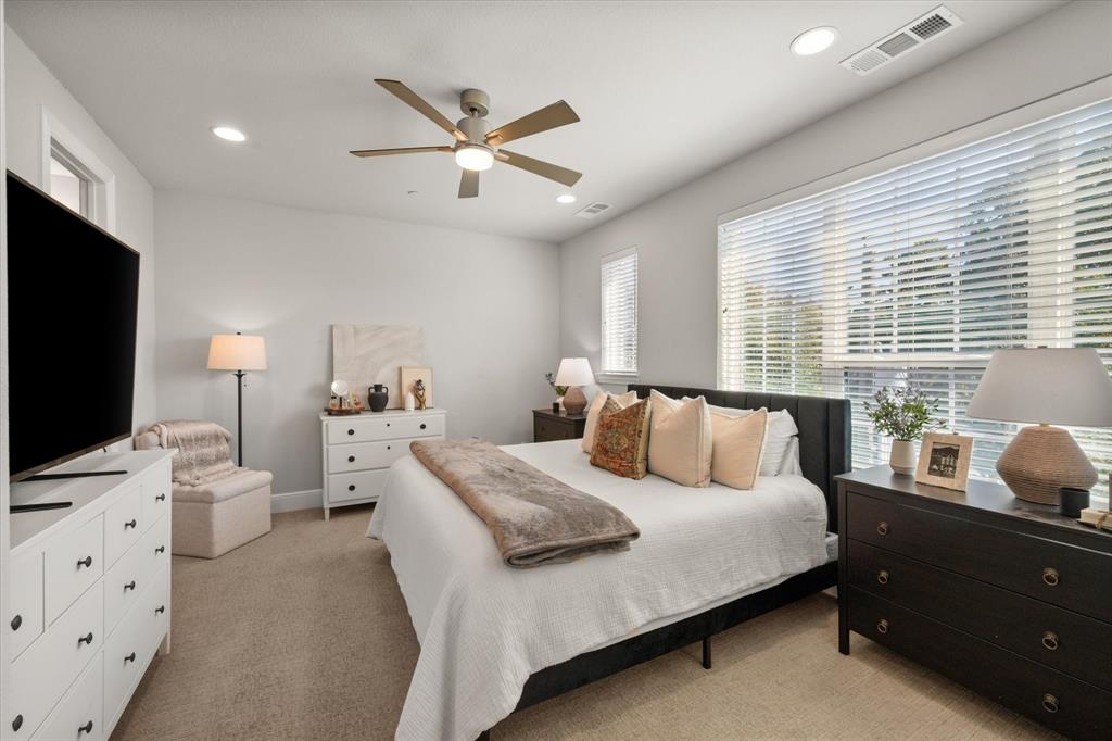 1900 Caddo Street, Unit 4 Dallas, TX 75204 - Photo 26 of 36 a bedroom with a bed and a flat screen tv