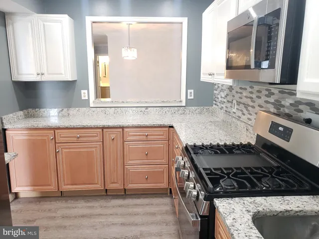 a kitchen with granite countertop a stove and a granite counter tops