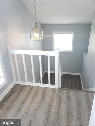 a view of wooden floor and windows in a room
