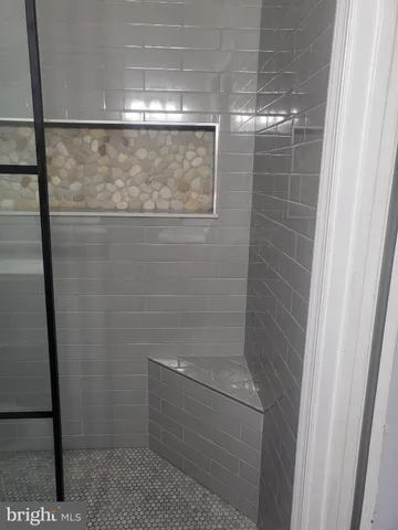 a bathroom with a glass shower door