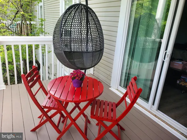 a balcony with chairs and wooden floor