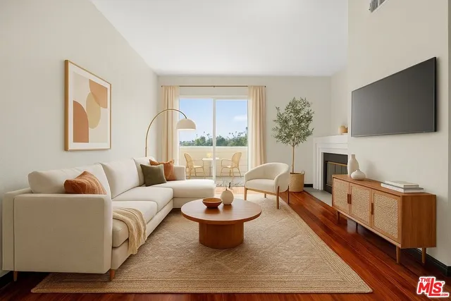 a living room with furniture a flat screen tv and a fireplace