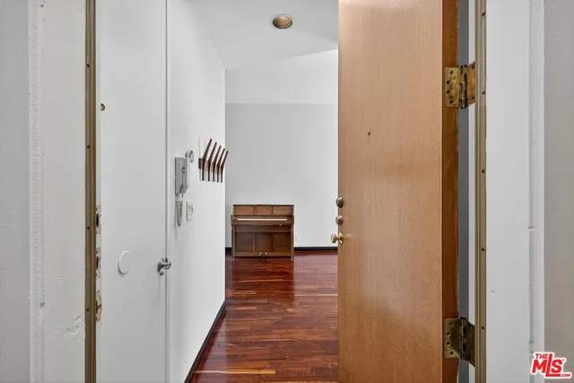 a view of an empty room with window and fire place