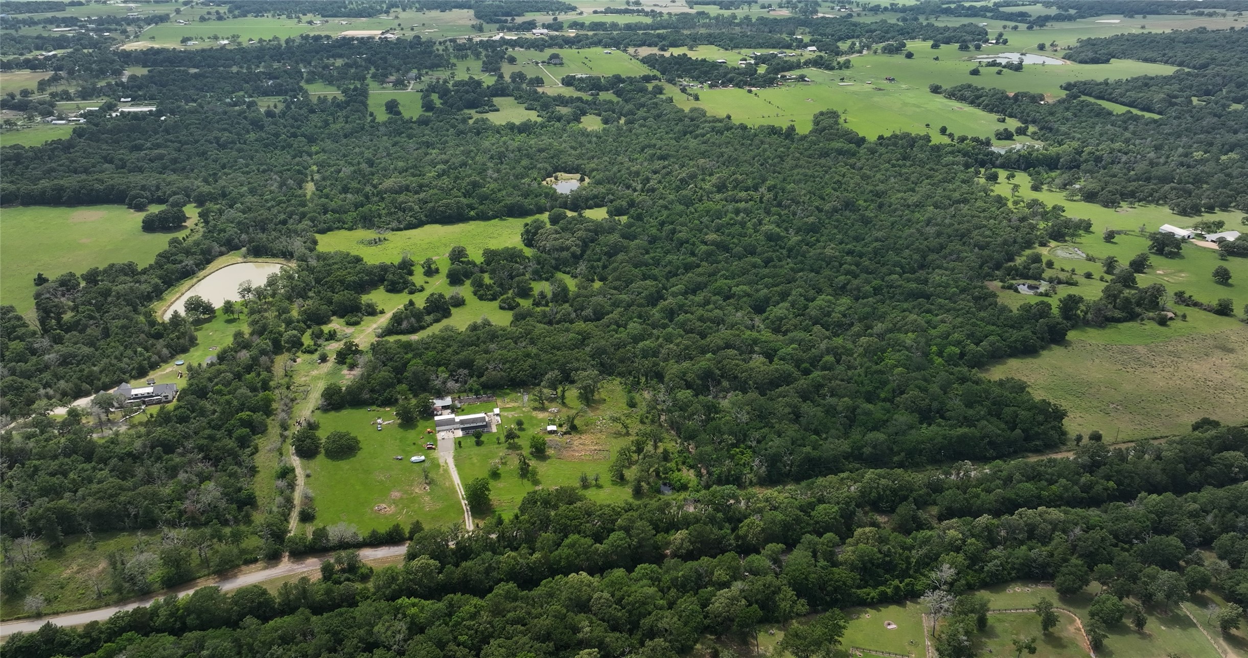 27296 Rock Island Road Hempstead, TX 77445 - Photo 20 of 30 an aerial view of residential houses with outdoor space and trees