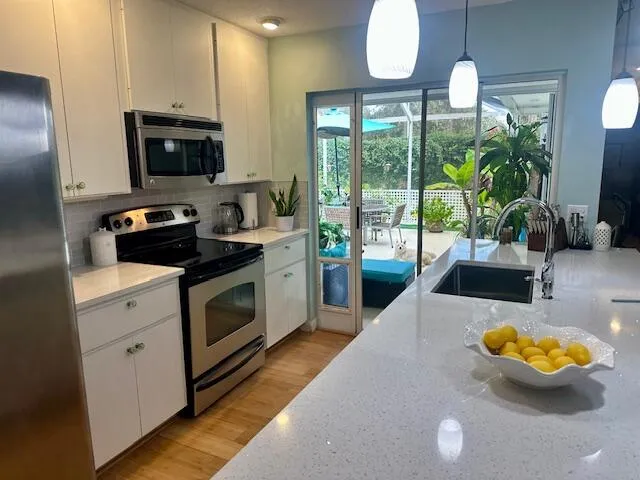 a kitchen with a stove a sink and a microwave