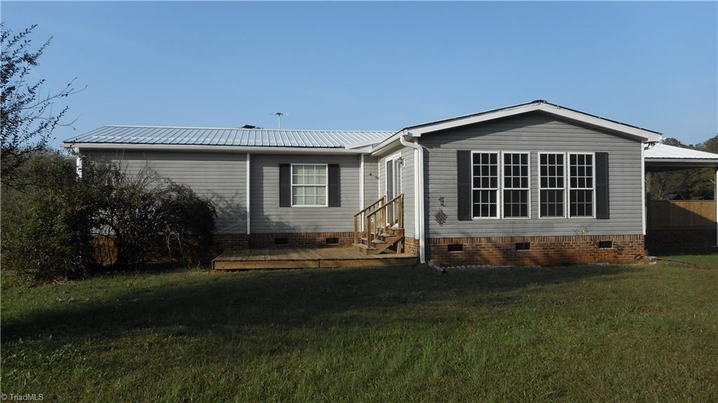 Large Row Of Leland Cypress Between Road & House Provide Shade & Privacy