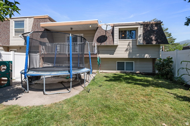 553 North 200 West Bountiful, UT 84010 - Photo 22 of 26 Rear view of property featuring mansard roof, a trampoline, a shingled roof, and a patio area