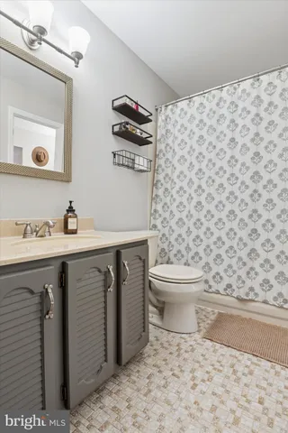 a bathroom with a toilet a sink and mirror