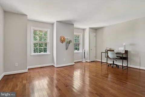 a view of livingroom with hardwood floor and workspace