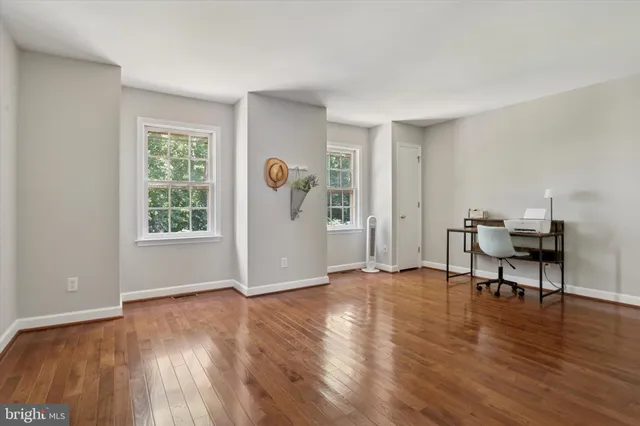 a view of livingroom with hardwood floor and workspace