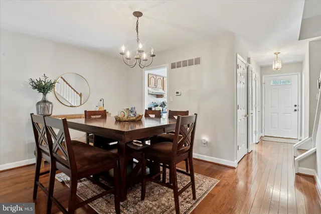 a view of a dining room with furniture wooden floor and chandelier