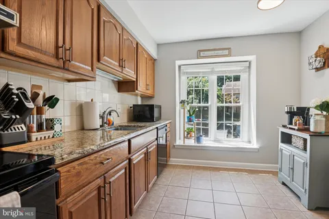 a kitchen with stainless steel appliances granite countertop a stove and a sink