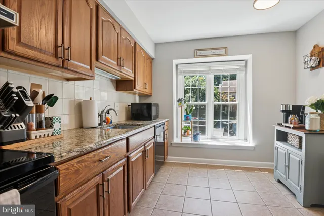 a kitchen with stainless steel appliances granite countertop a stove and a sink