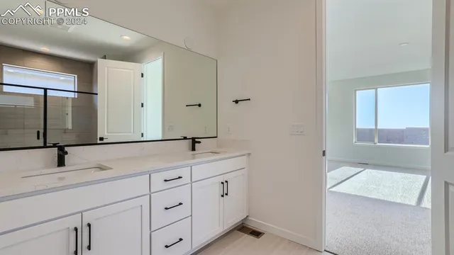 a bathroom with a glass shower door