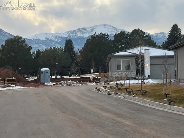 a view of a house with a wooden fence