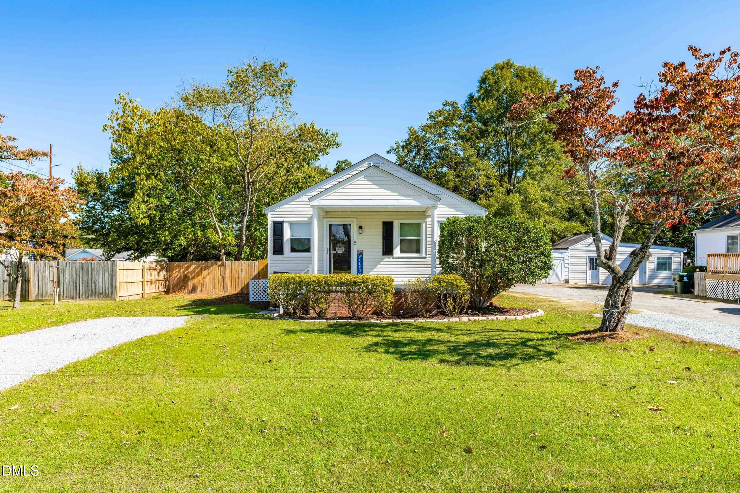 305 North 10th Street Erwin, NC 28339 - Photo 2 of 36 a front view of a house with swimming pool and green space