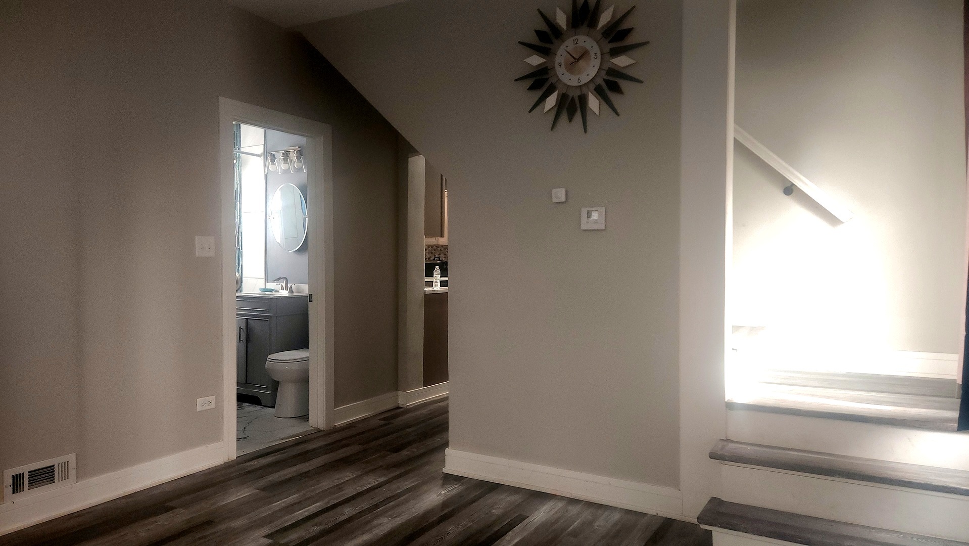 13331 South Calumet Avenue Chicago, IL 60827 - Photo 5 of 35 a hallway with wooden floor windows and a chandelier