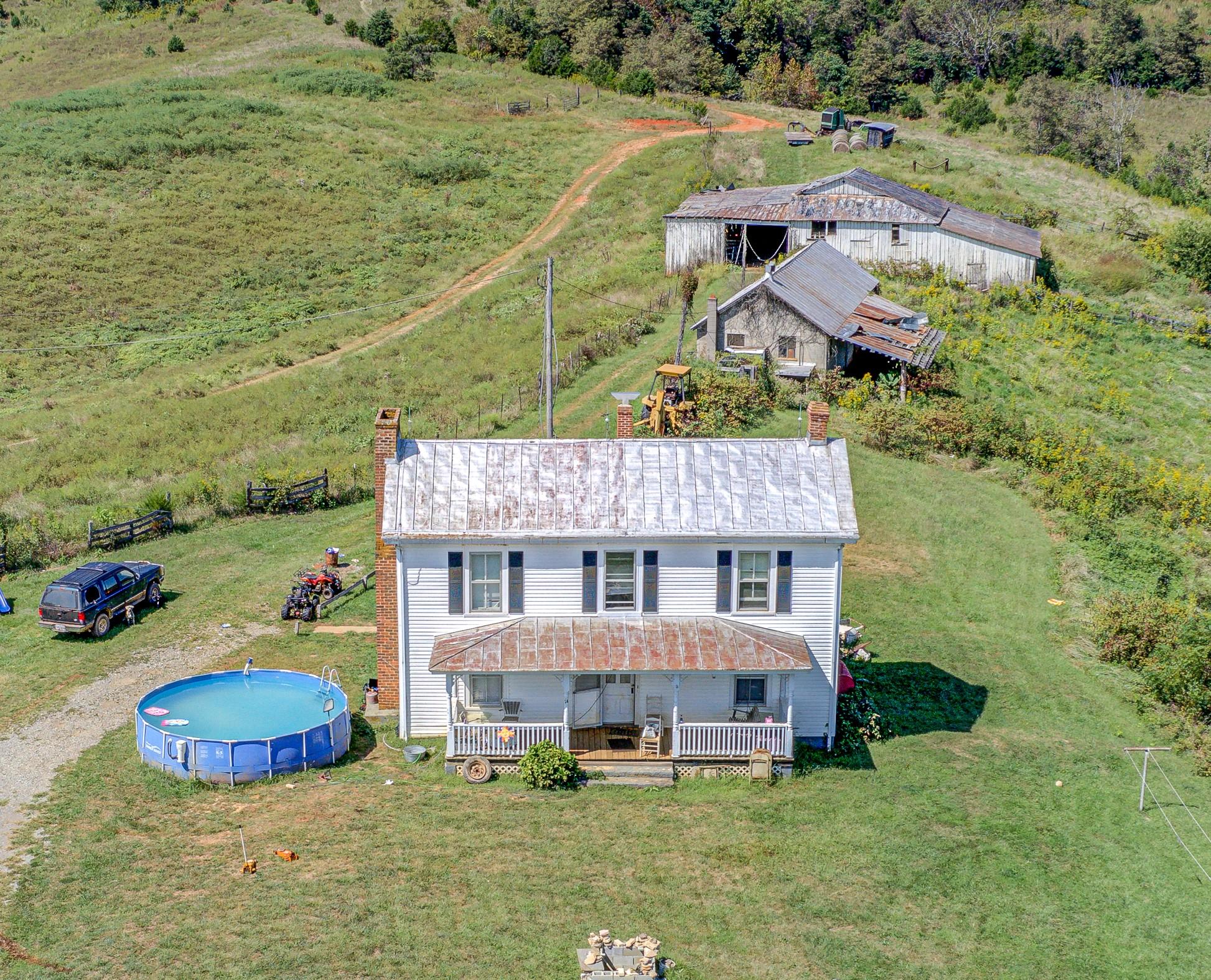 1375 Simmons Mill Road Thaxton, VA 24174 - Photo 1 of 30 an aerial view of a house with swimming pool and lake view