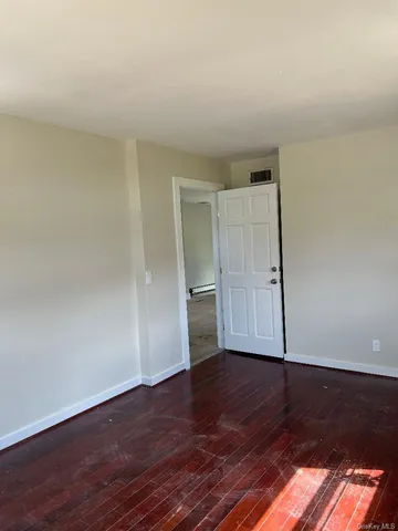 an empty room with wooden floor