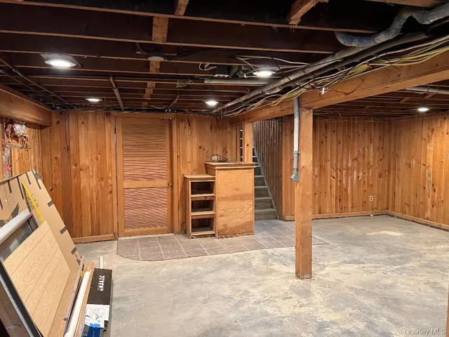 a view of an empty room with wooden wall