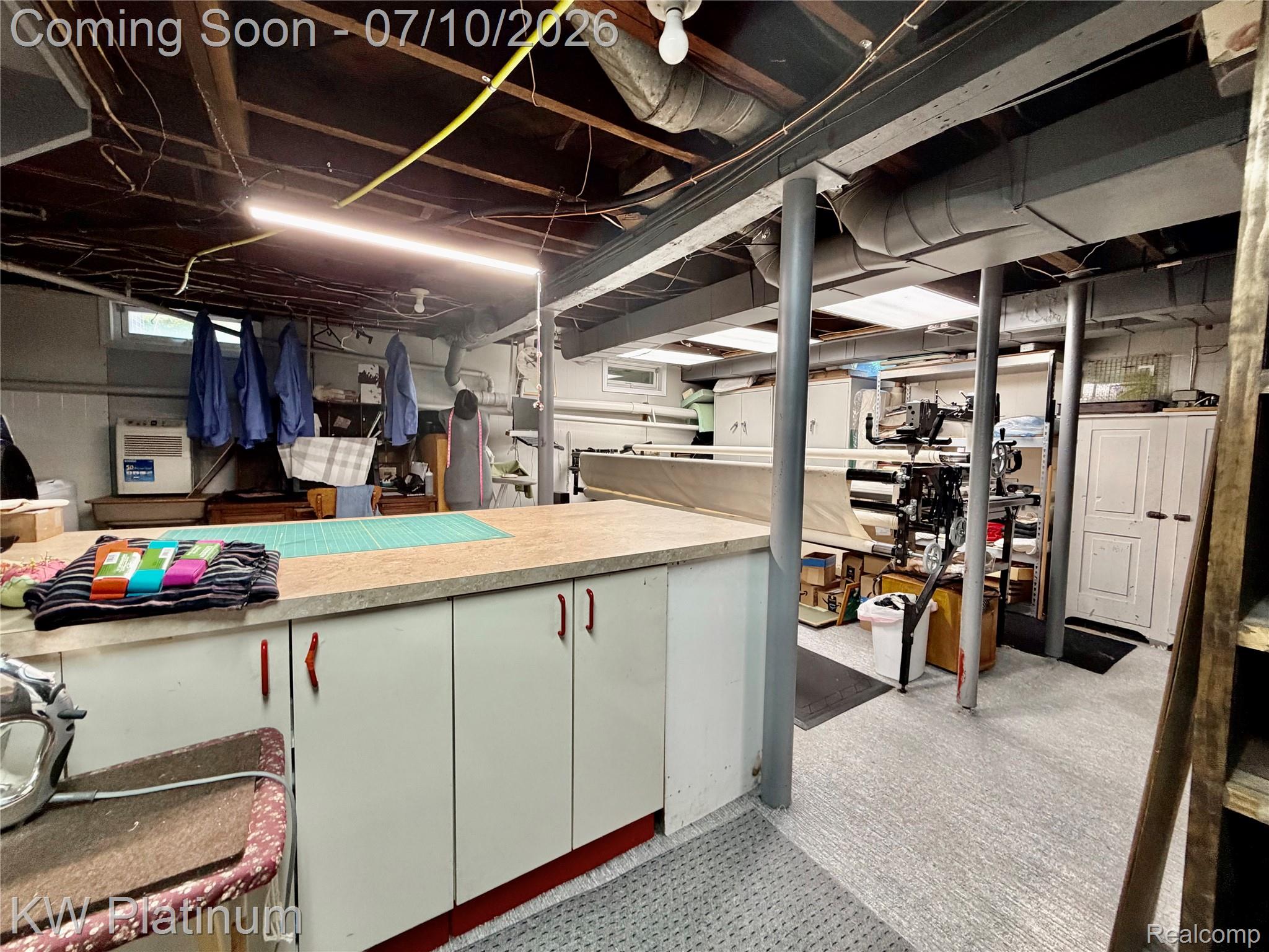1581 Emerson Road Goodells, MI 48027 - Photo 18 of 45 Utility space featuring an exposed beam ceiling, overhead lighting, and dedicated workspace cabinetry with a light-toned countertop