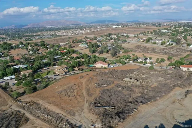 an aerial view of mountain with yard