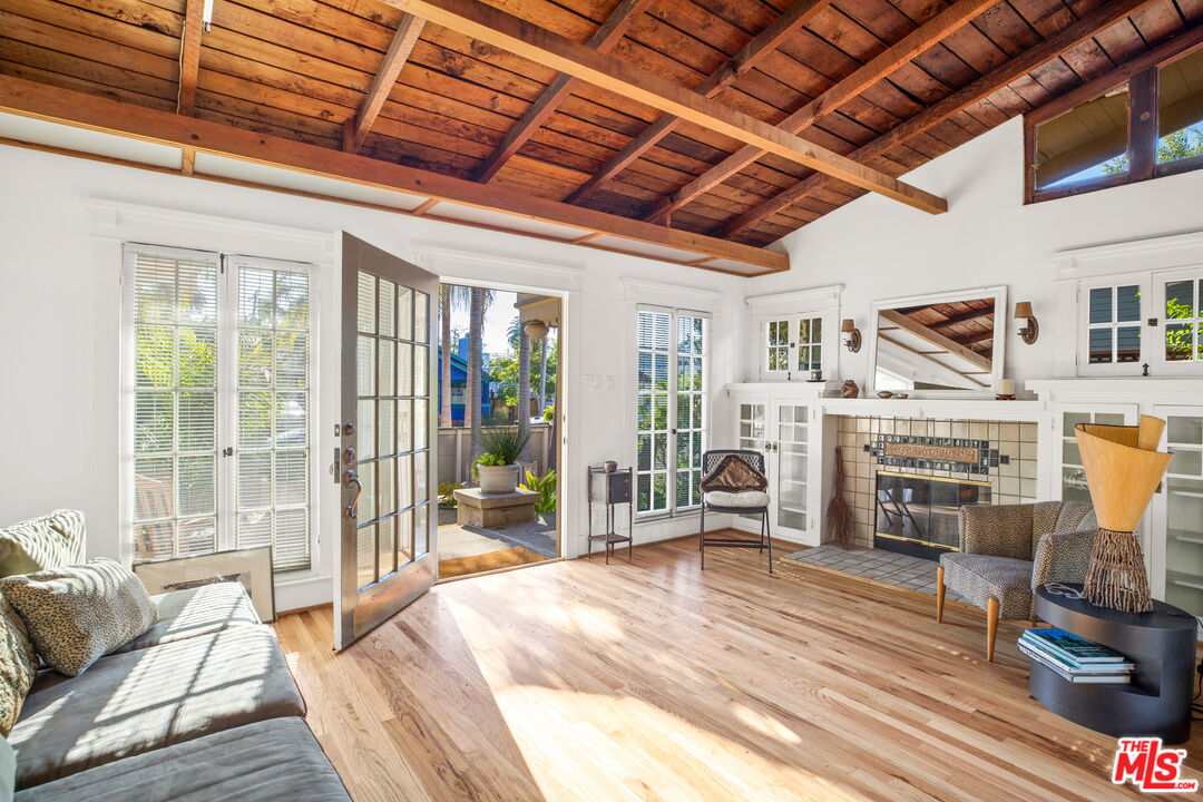 761 Palms Boulevard Venice, CA 90291 - Photo 4 of 26 a room with lots of wooden furniture and a chandelier