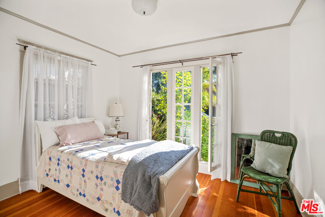 761 Palms Boulevard Venice, CA 90291 - Photo 9 of 26 a bedroom with a bed and wooden floor